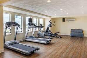 A fitness room with treadmills, a stationary bike, and a rowing machine. - Atlantic Beach Hotel Newport (Middletown)