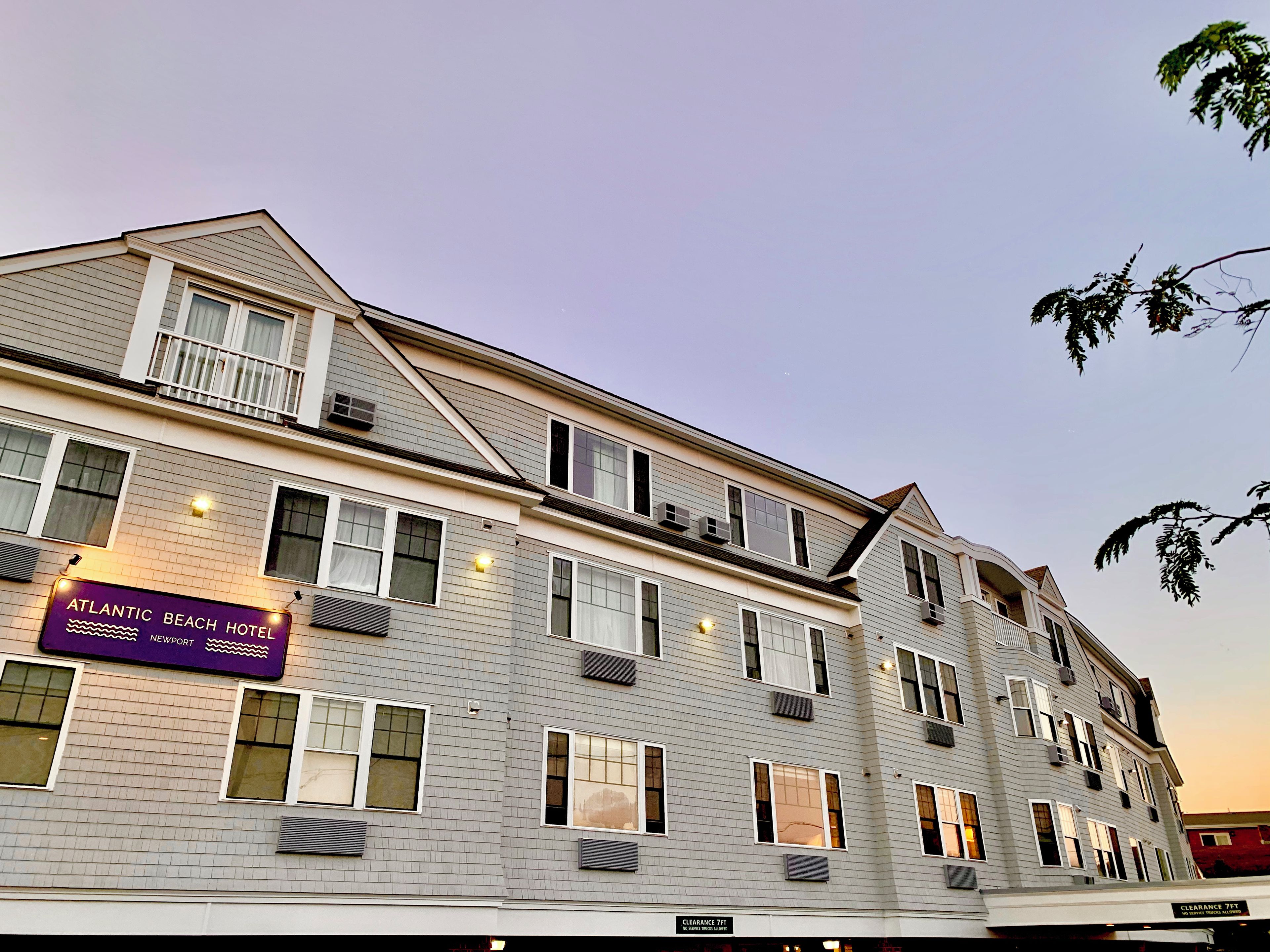 A multi-story hotel with a sign for the Atlantic Beach Hotel in Newport.