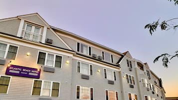 A multi-story hotel with a sign for the Atlantic Beach Hotel in Newport.