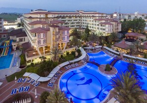 A hotel with multiple swimming pools, a children's play area, and a landscaped garden. - Nova Park (Manavgat)