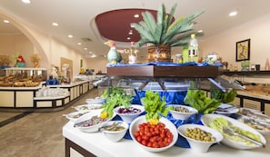 A buffet with various food items and a decorative centerpiece. - Nova Park (Manavgat)