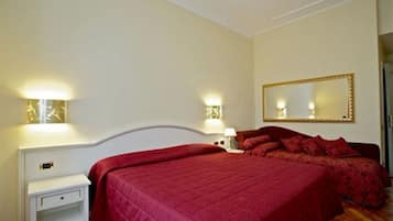 A bedroom with a large bed, two bedside tables, a nightstand, and a mirror on the wall.