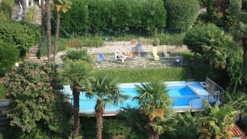 Seasonal outdoor pool, open 9:00 AM to 8:00 PM, pool umbrellas