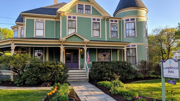 A two-story Victorian-style house with a turret and a porch. - LimeRock Inn (Rockland)
