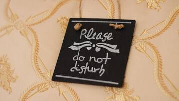 A black sign with white text on a beige fabric background.