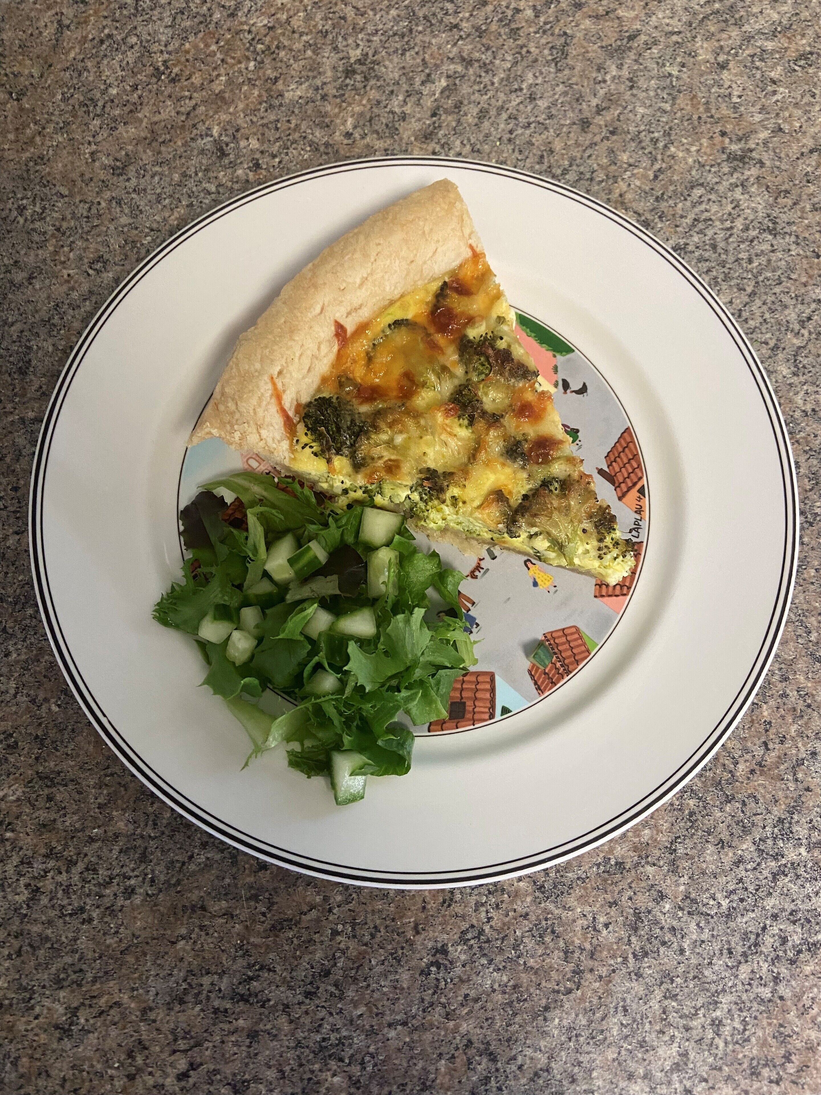 A slice of pizza with a side of mixed greens on a plate.