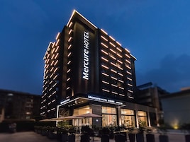 Un edificio moderno de hotel con un letrero llamativo que dice 'Mercure Hotel'.