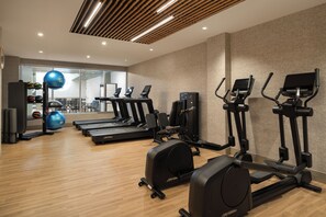 A gym with treadmills, elliptical machines, and exercise balls. - The Harborvale, Autograph Collection (Burlington)