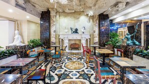 A luxurious interior with marble floors, classical statues, and a fireplace. - AC Embassy Hotel (Beijing)