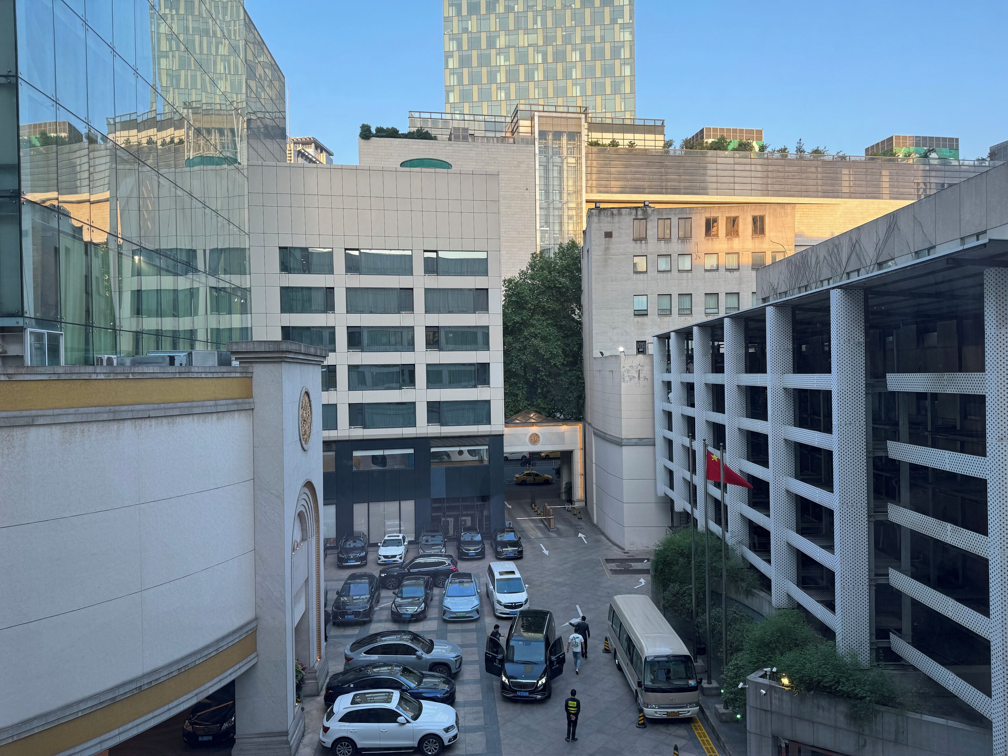 A multi-level parking garage with several cars and a bus.