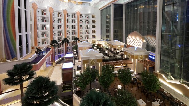 A multi-level hotel lobby with a central atrium, multiple floors, and a variety of seating areas. - Nanjing Central Hotel (Nanjing)