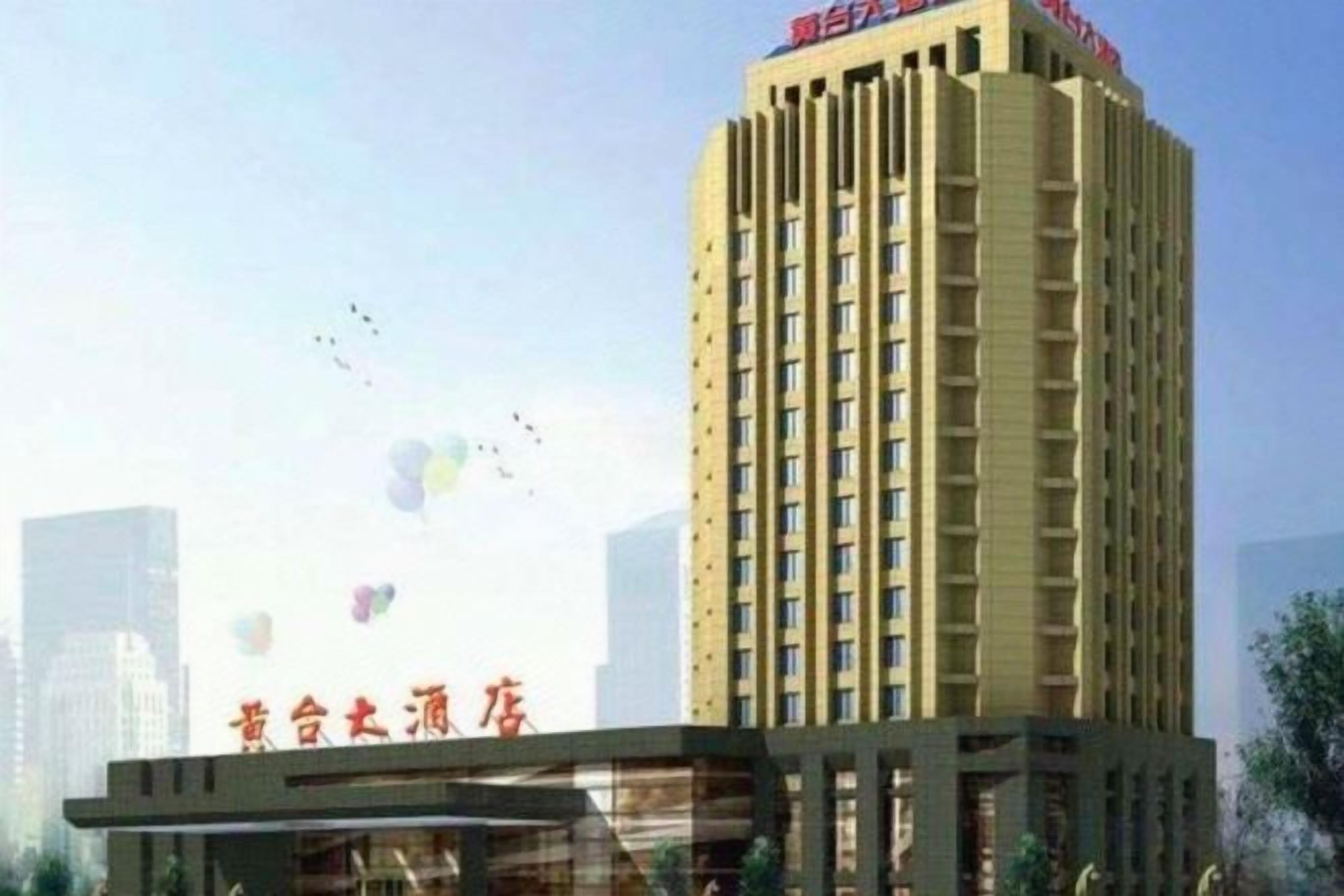A tall hotel building with a prominent sign at the top.