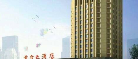 A tall hotel building with a prominent sign at the top.