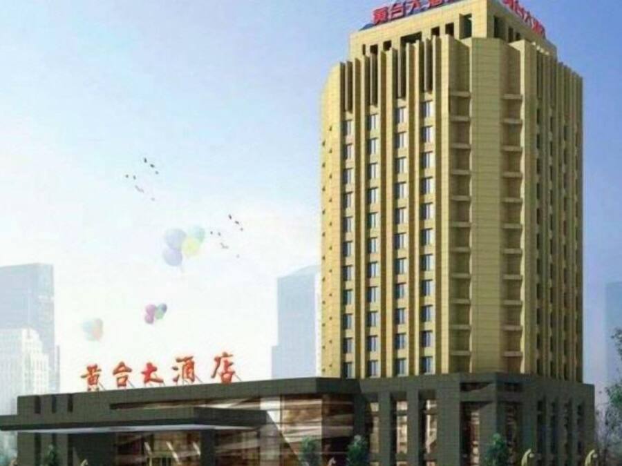 A tall hotel building with a prominent sign at the top.