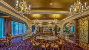 A grand hotel lobby with chandeliers, a round dining table, and a patterned carpet. - Regal Hotel (Guiyang)