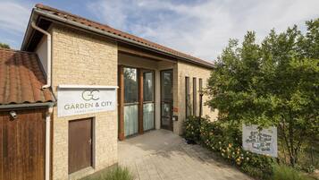 A building with a sign reading "Garden & City" and a brick facade.