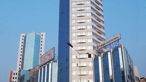 A modern high-rise building with a prominent sign for the Bank of China. - Celeste Palace Hotel (Jiangmen)