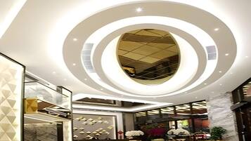 A modern lobby with a circular skylight and a central column.