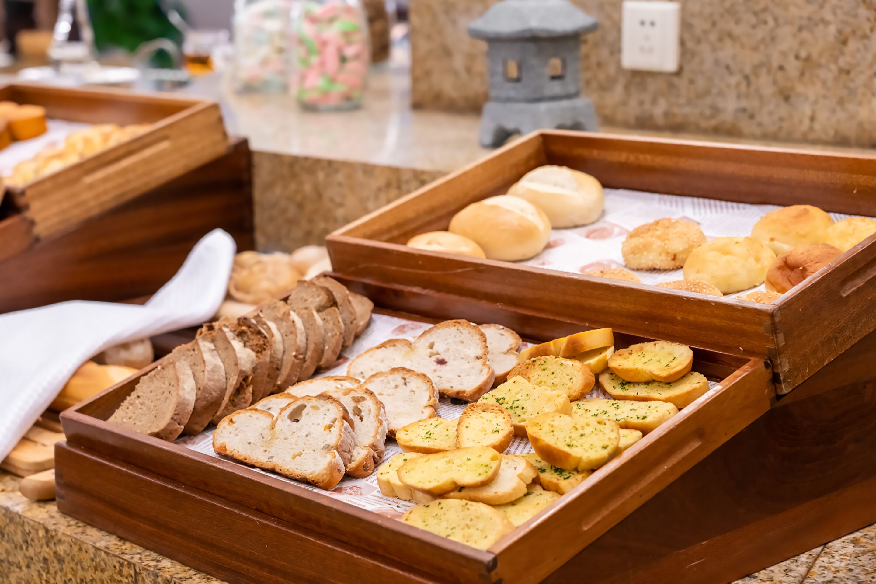 A buffet with various bread and pastries.