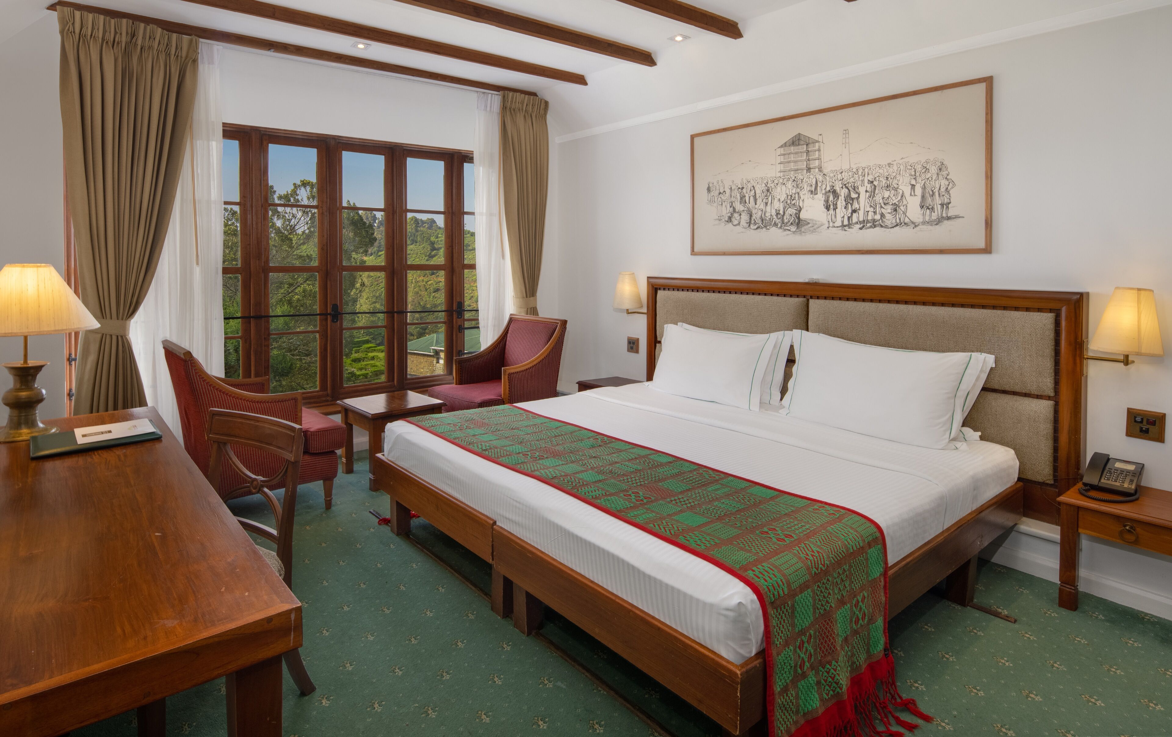 A hotel room with a large bed, a desk, a chair, and a window with curtains.