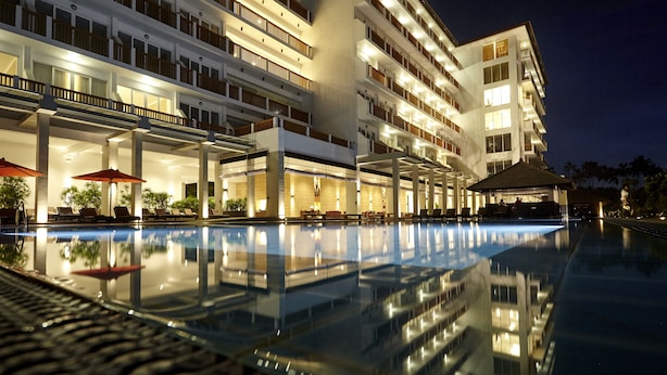 A hotel with a swimming pool, multiple balconies, and outdoor seating areas. - Turyaa Kalutara (Wadduwa)