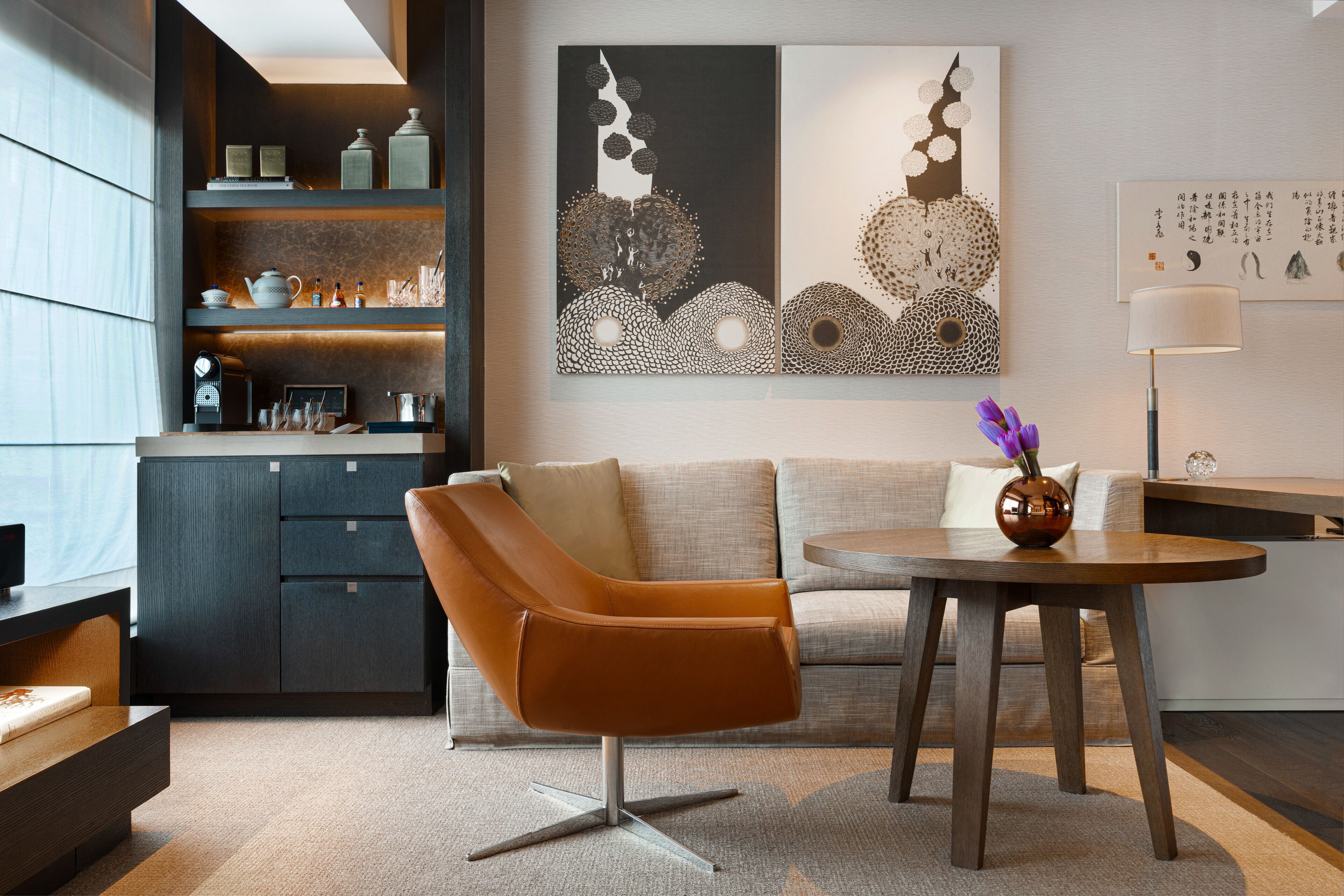 A modern living room with a sofa, a coffee table, and a decorative vase.