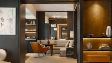 A modern interior with a sofa, a round table, and a bookshelf.