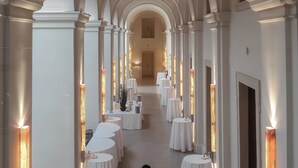 A corridor with arched ceilings and evenly spaced tables, suggesting a formal setting. - Mandarin Oriental, Prague (Prague)