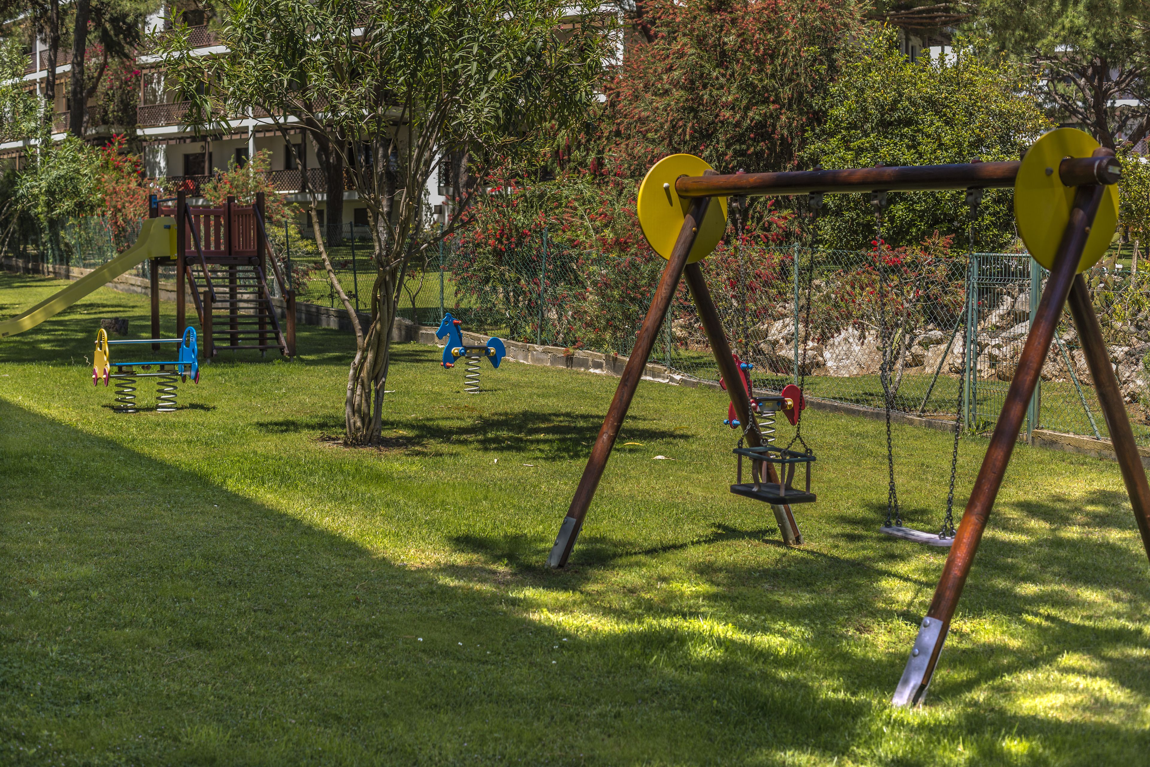 A playground with swings, slides, and climbing structures.