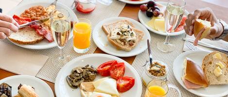Un desayuno con diferentes platos, como tostadas, huevos y fruta.