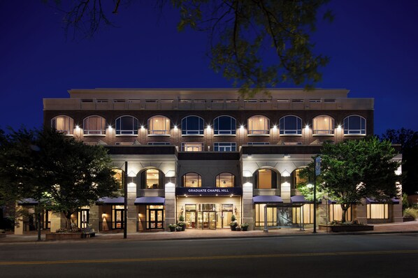 A multi-story building with a prominent entrance, arched windows, and a sign reading "GRADUATE CHAPEL HILL". - Graduate by Hilton Chapel Hill (Chapel Hill)