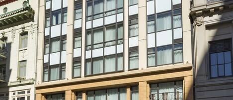 A multi-story hotel with a classic architectural design, featuring large windows and a prominent entrance.