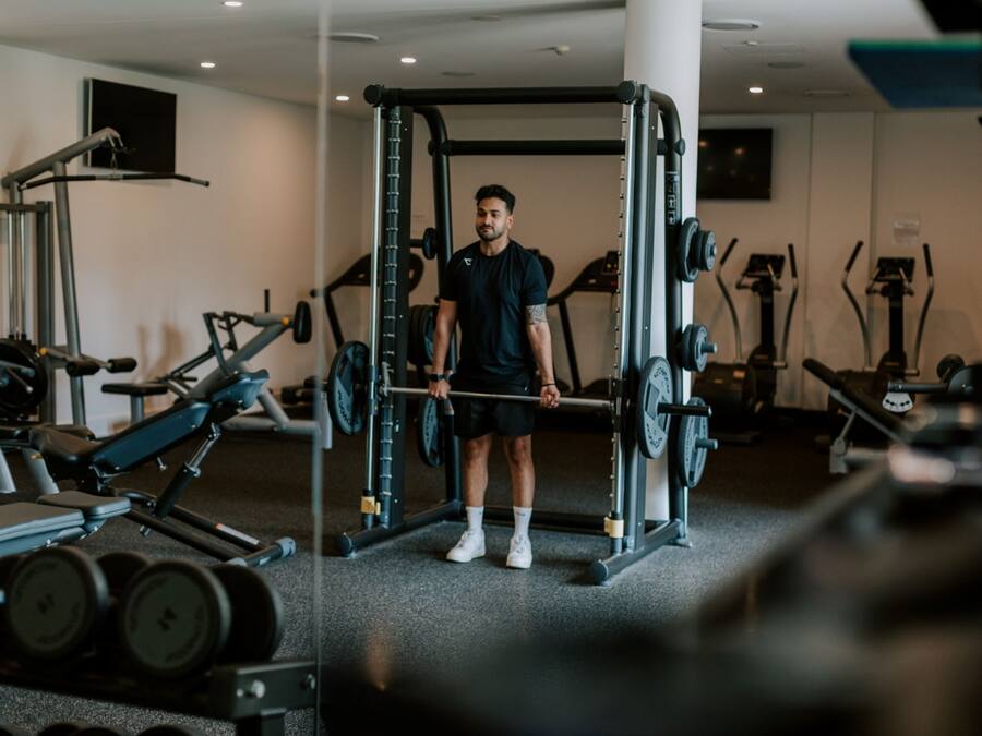 A gym with weightlifting equipment, treadmills, and stationary bikes.