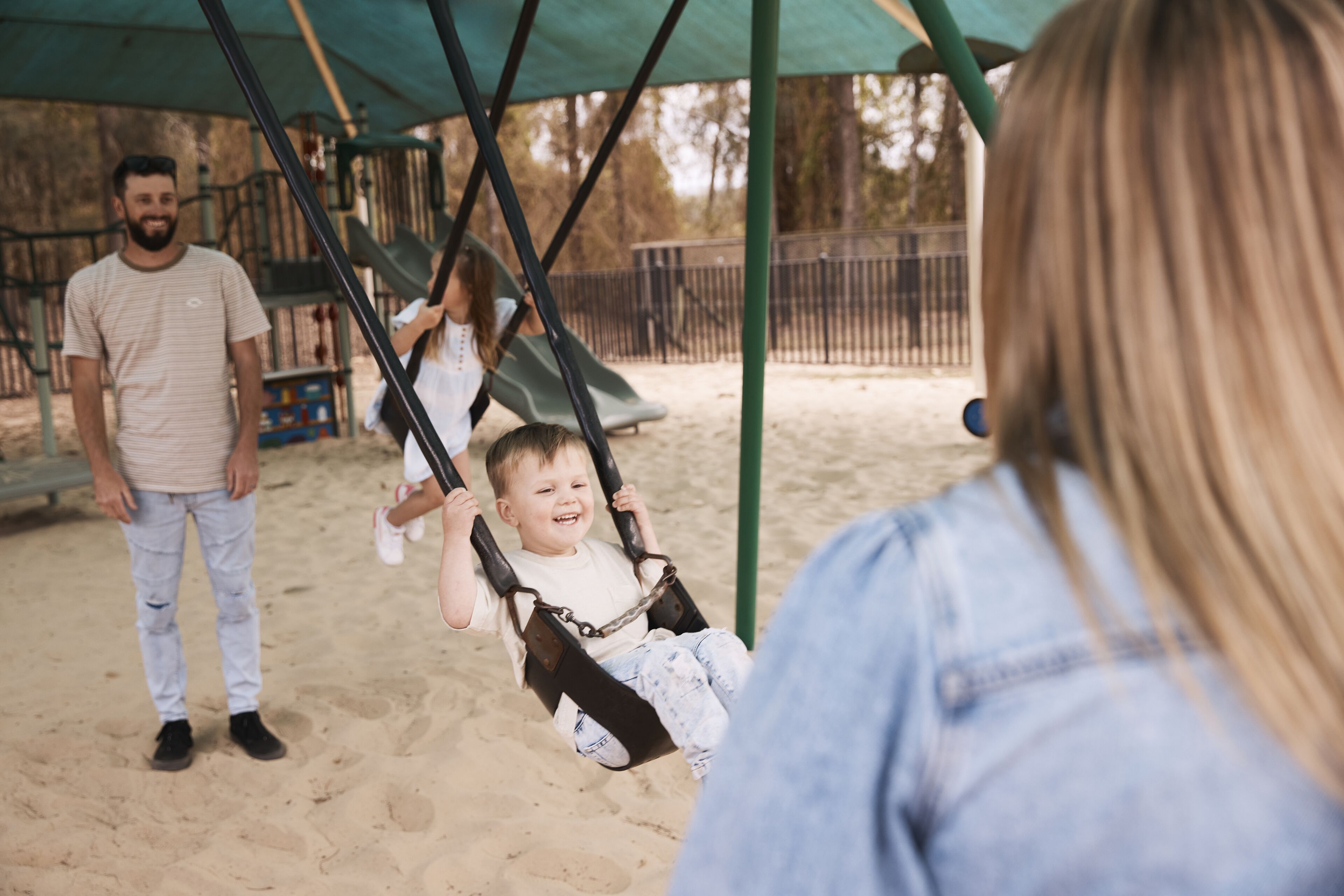 A playground with swings and a slide.