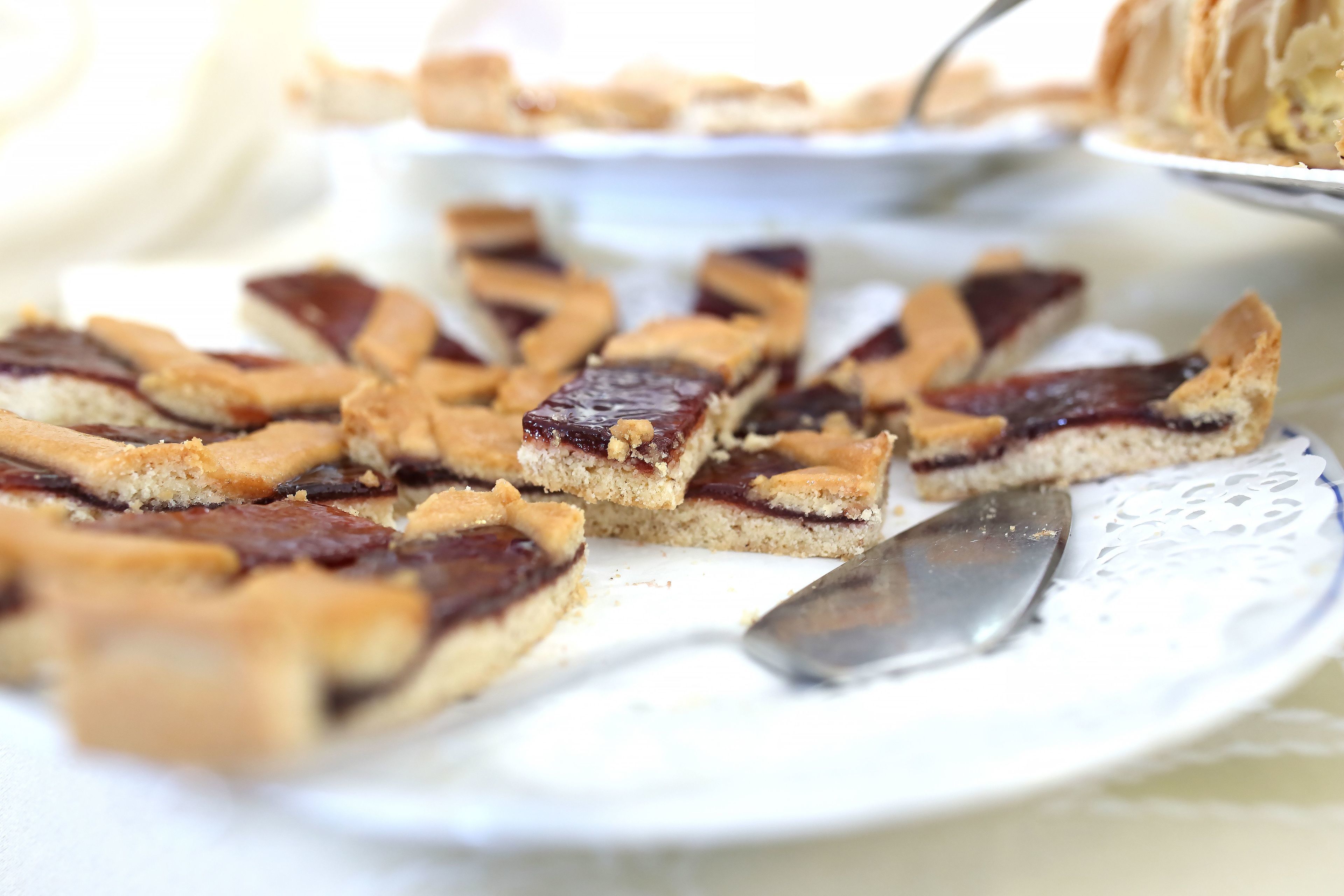 A plate of dessert bars with a knife on it.
