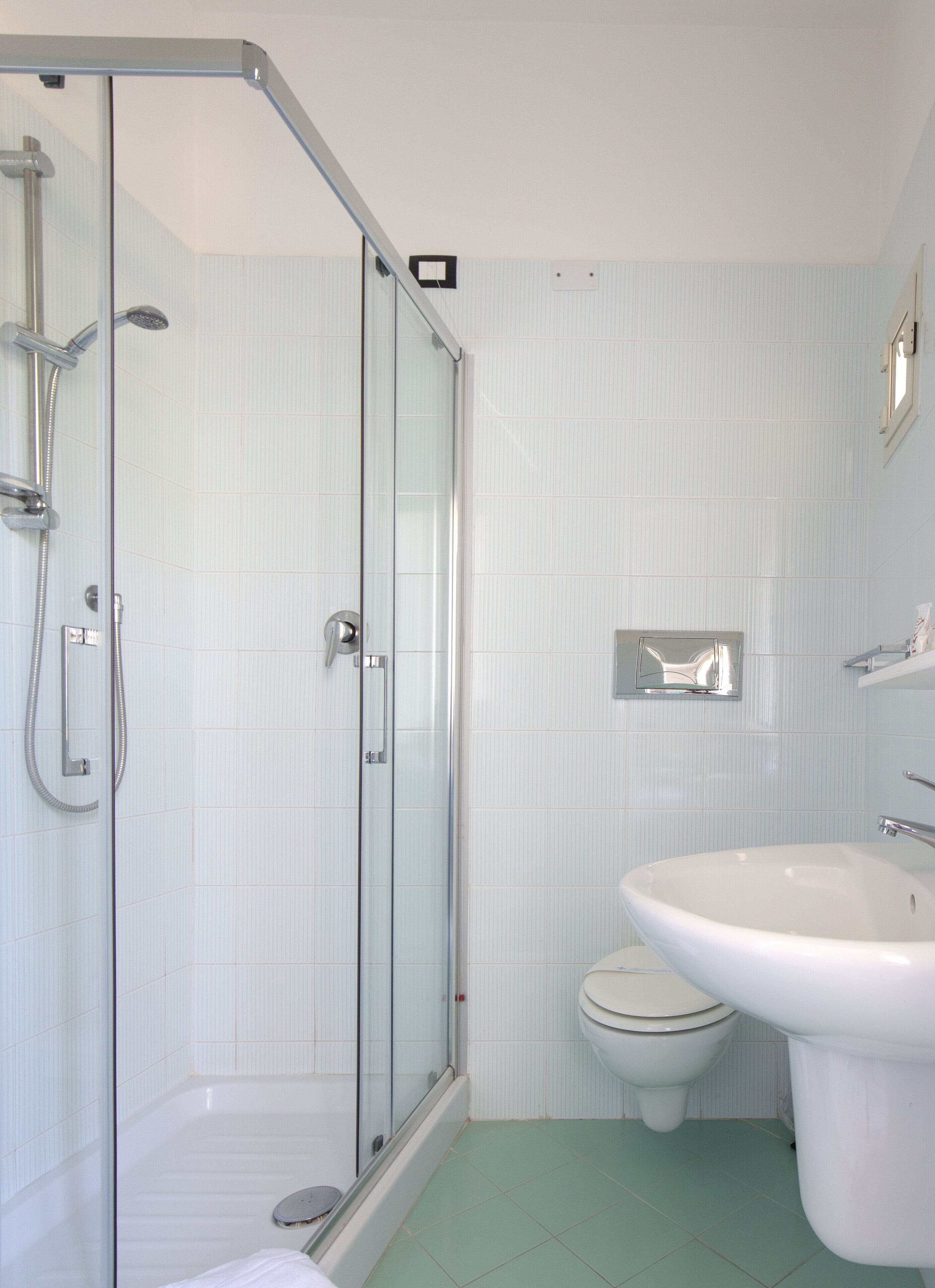 Shower, rainfall showerhead, hair dryer, towels