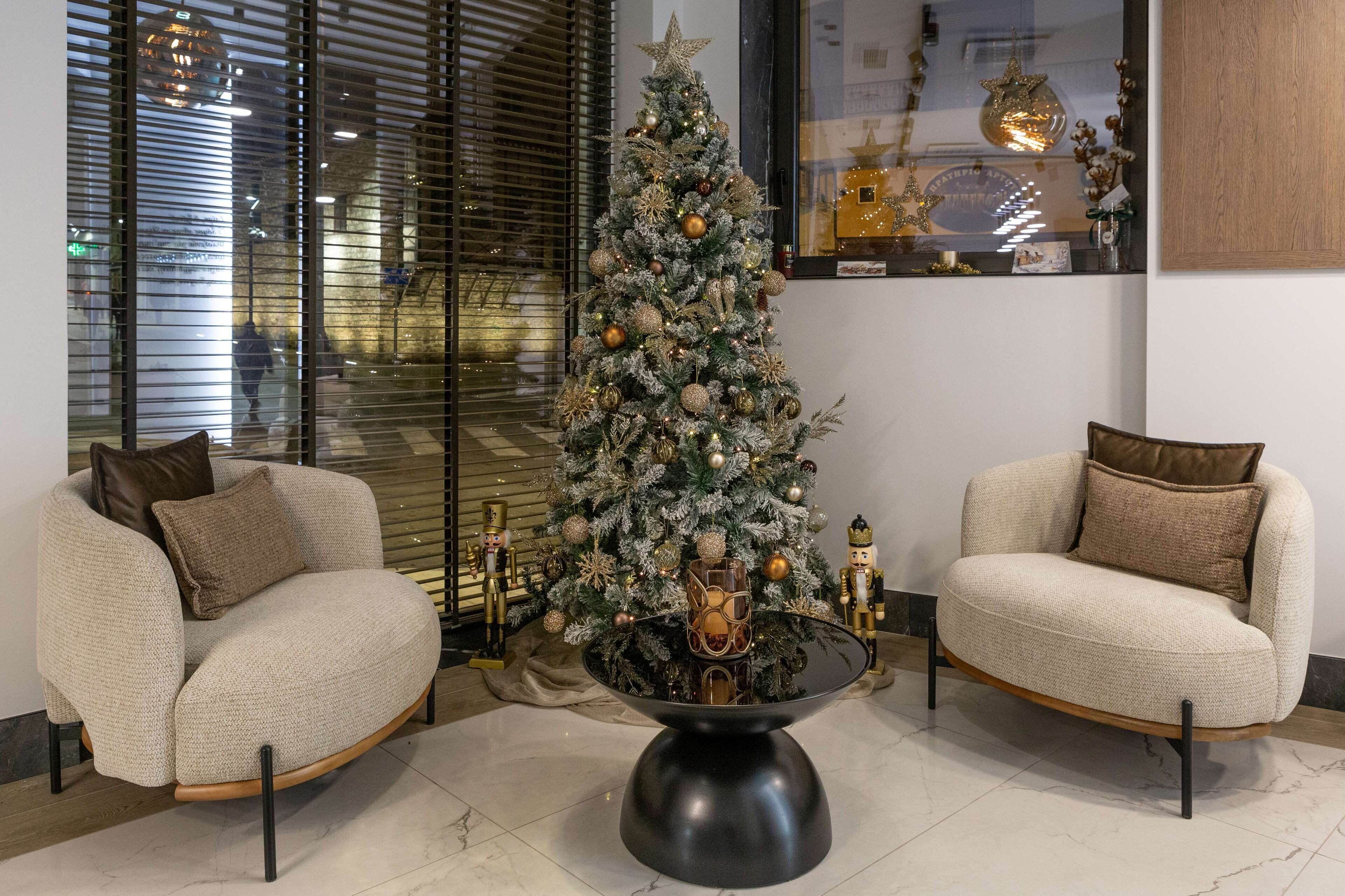 A modern interior with a Christmas tree, two sofas, and a coffee table.