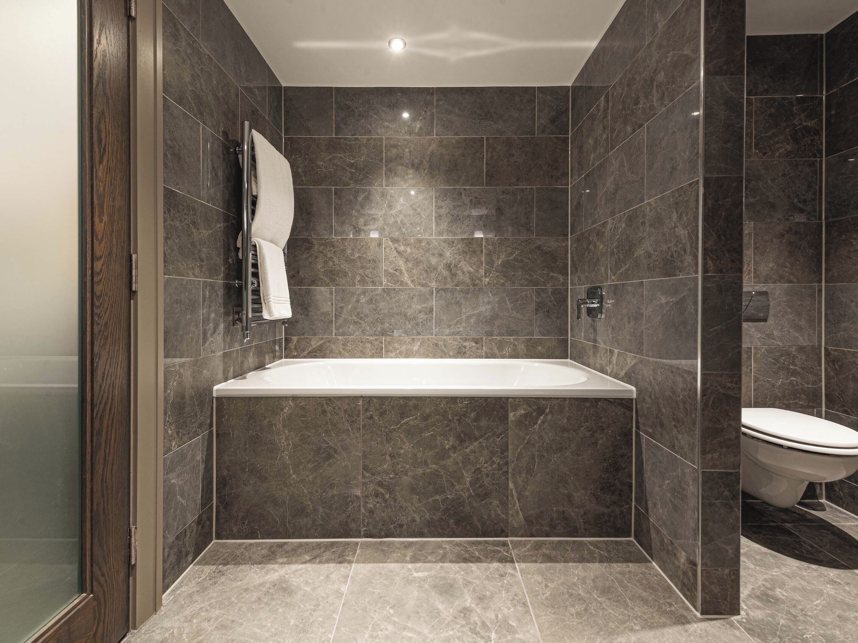 signature suite | bathroom | shower, rainfall showerhead, designer toiletries, hair dryer
