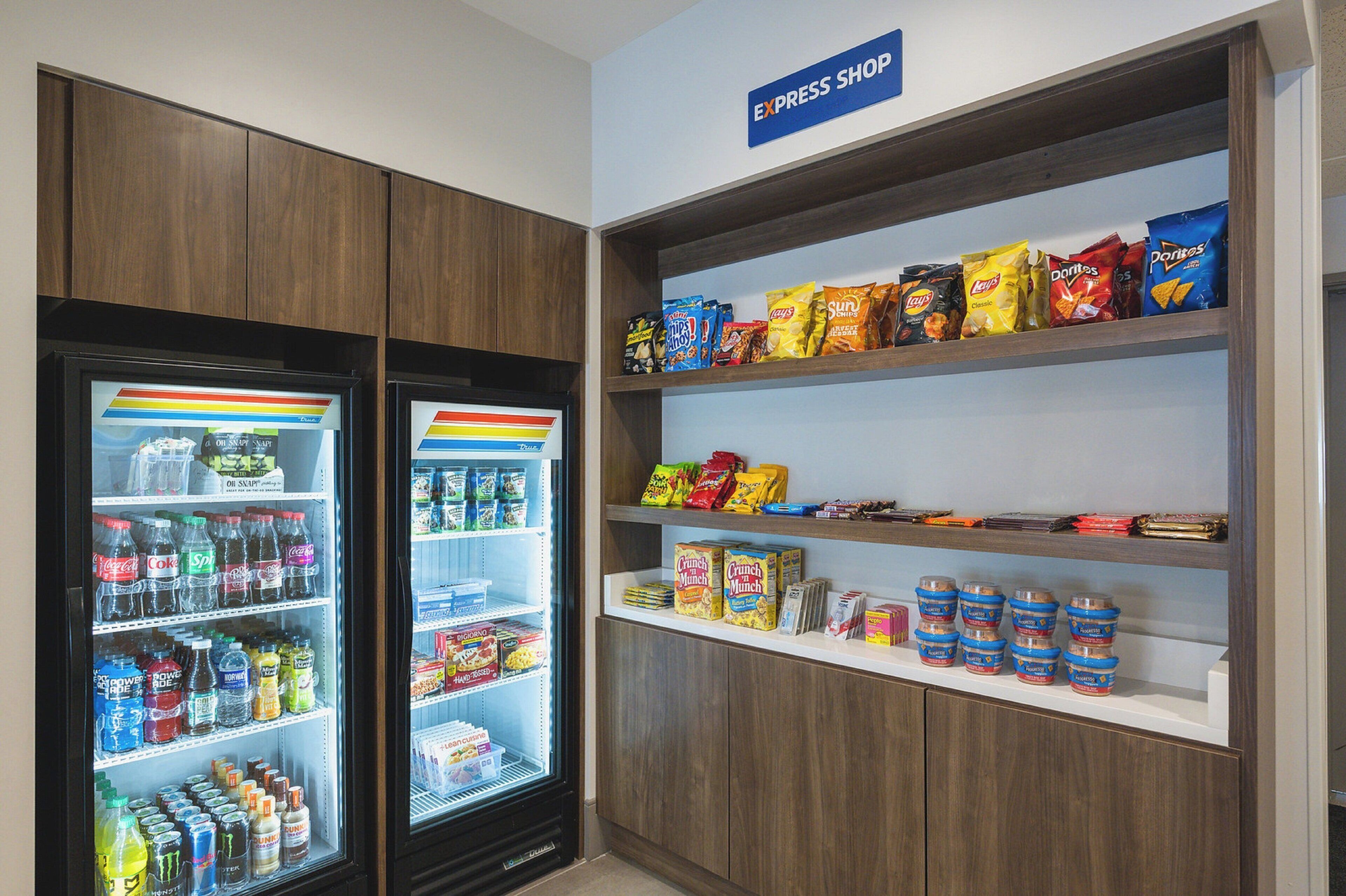 A snack and beverage display in a store with various snacks and drinks.