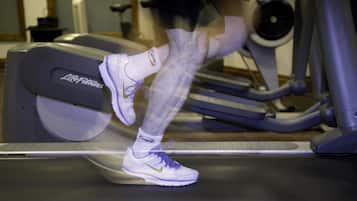 A treadmill with a visible brand name and a person using it.