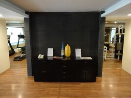 A reception desk with a phone, a yellow vase, and a blue vase.