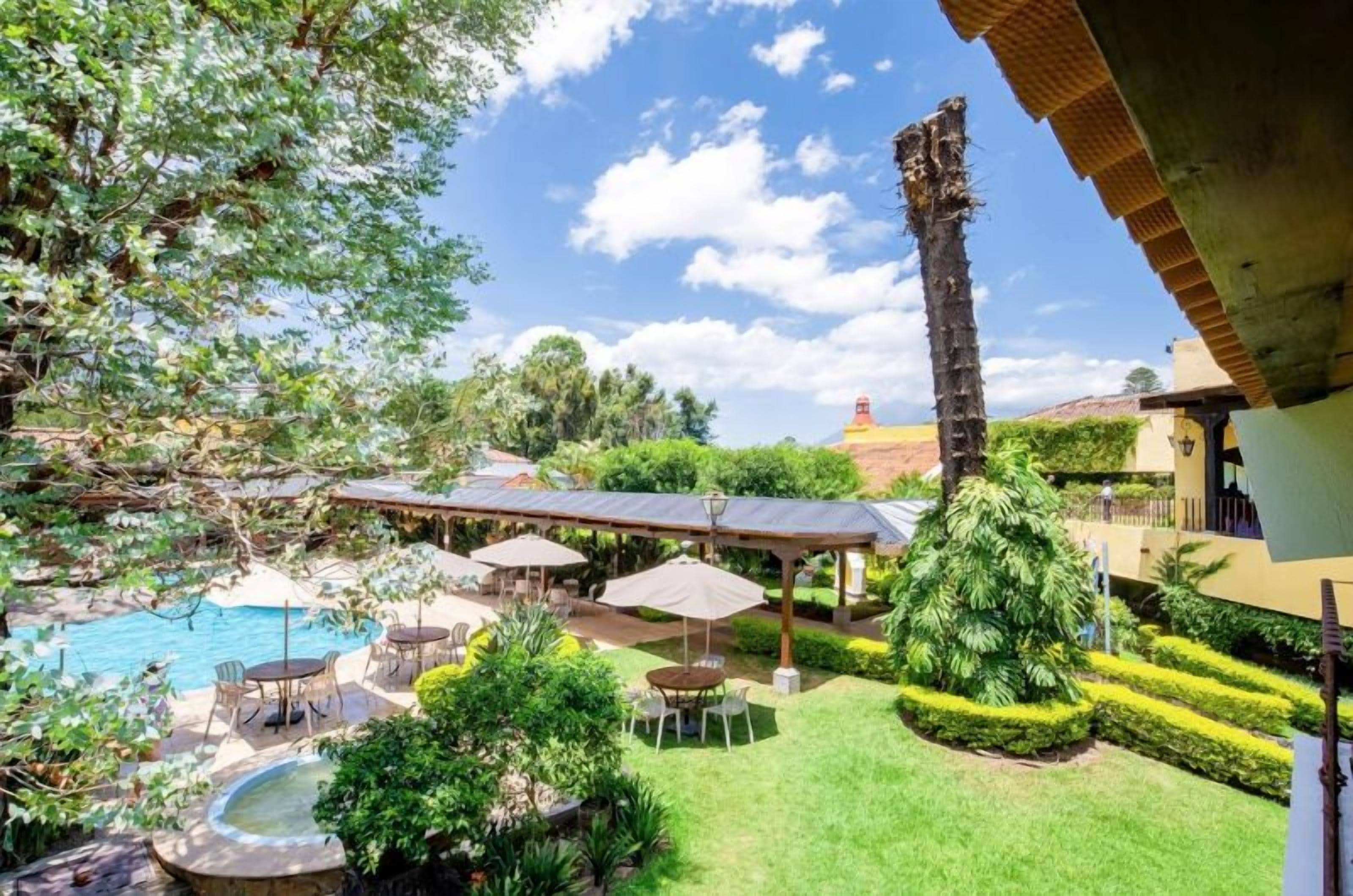 A backyard with a swimming pool, outdoor seating, and well-maintained landscaping.