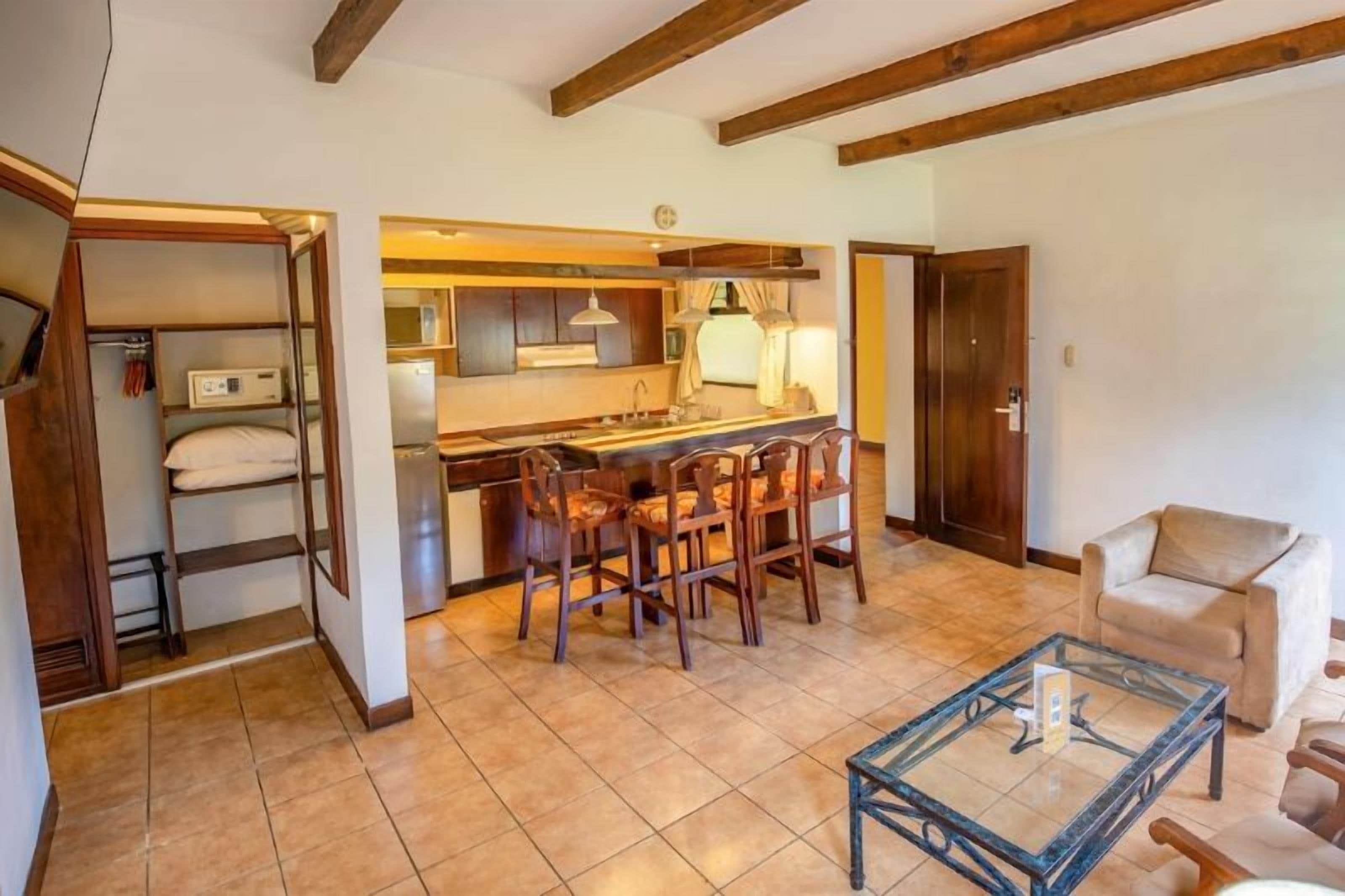 A compact living space with a kitchen area, a dining table, and a seating arrangement.