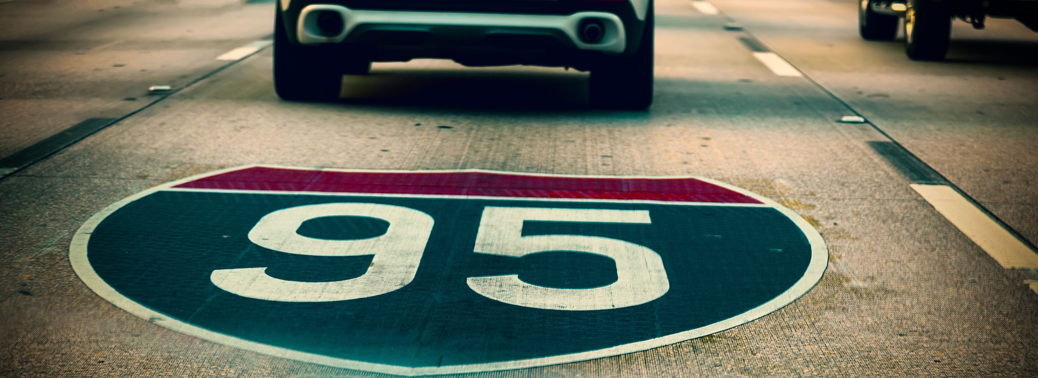 A road sign with the number 95 on a highway.