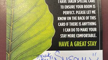 A welcome sign with a leaf design and a message about room care.