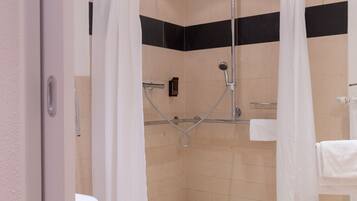 A modern bathroom with a shower enclosure, a toilet, and a sink.