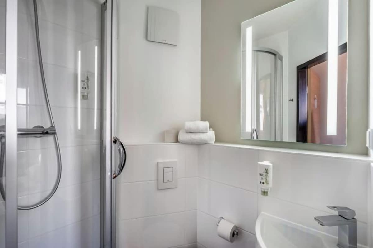 Shower, hair dryer, towels, soap