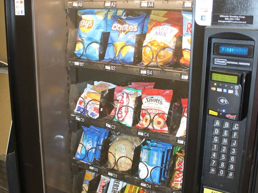 A vending machine stocked with various snacks and beverages.