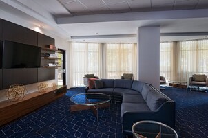 A modern living room with a sectional sofa, a flat-screen TV, and a coffee table.