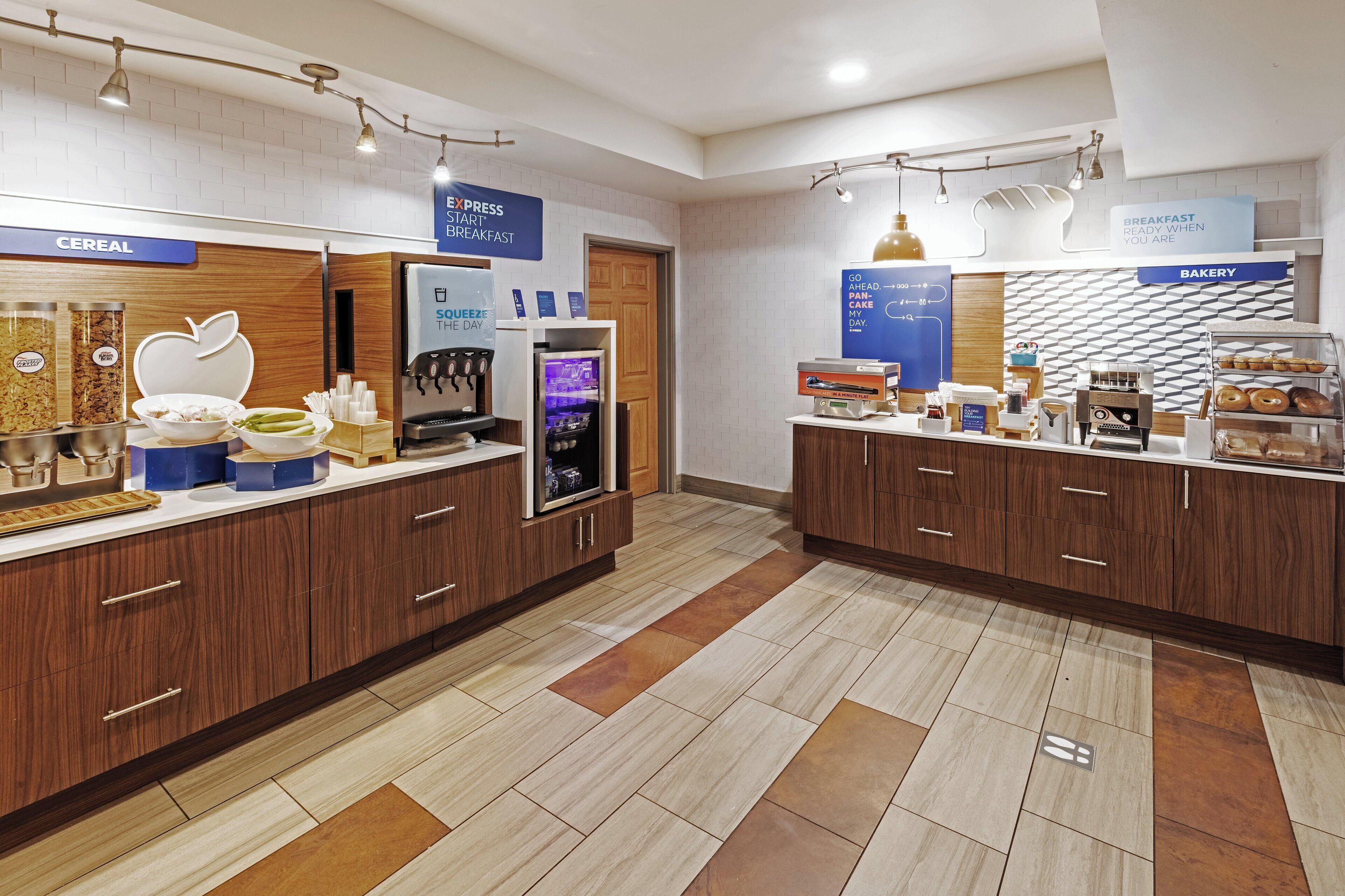 A breakfast area with cereal, a smoothie bar, and a bakery section.